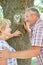 Senior couple in front of tree with chalk heart