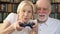 Senior couple gamers playing video game at home. Players with remote controller of game console