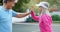 Senior couple giving high five in tennis court 4k