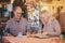 Senior couple giving a look to menu in typical Italian restaurant