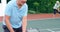 Senior couple giving thumps up to each other while playing tennis 4k