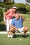 Senior Couple Golfing On Golf Course