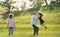 Senior couple with granddaughter outside in spring nature, having fun.