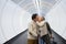 Senior couple in hallway of subway pulling trolley luggage.