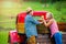 Senior couple harvesting apples, standing at vintage red car