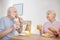 Senior couple having breakfast and looking contented