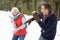 Senior Couple Having Snowball Fight In Snow