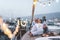 Senior couple having tender moment on boat while drinking champagne and eating fruits - Focus on faces