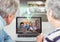 Senior couple having video call with family on laptop