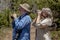 Senior Couple Hiking and Birdwatching in Woods on a Sunny Day