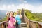 senior couple hiking on the mountain with thumbs up