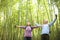 Senior Couple hiking and relaxing in green bamboo