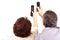 Senior couple hold mobile phones in hand