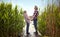 Senior couple holding hands, looking up, laughing,  standing on a platform by the river