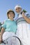 Senior Couple Holding Tennis Racquet And Balls