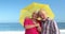 Senior couple holding umbrella