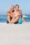 Senior Couple On Holiday Sitting On Sandy Beach