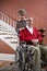 Senior couple at home, man in wheelchair
