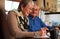 Senior Couple At Home Sitting At Table Checking Personal Finances