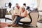 Senior Couple In Hotel Lobby Looking At Digital Tablet