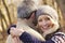 Senior couple hugging outdoors in winter