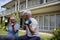 Senior couple interacting while exercising with dumbbells