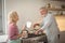 Senior couple interacting while preparing food