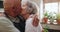 Senior, couple and kiss in kitchen with love, support and care in marriage and retirement. Elderly, man and woman
