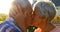 Senior couple kissing in backyard 4k