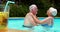 Senior couple kissing each other in the pool