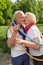 Senior couple kissing in a hoop in nature