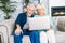 Senior couple with a laptop indoors