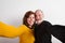 Senior couple in love hugging, taking selfie. Studio shot.