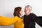 Senior couple in love hugging, taking selfie. Studio shot.