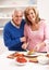 Senior Couple Making Sandwich In Kitchen