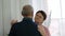 Senior couple, mature man and elderly woman dancing in the kitchen