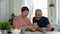 Senior couple, mature man and elderly woman looking at smartphone, video call