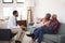 Senior Couple Meeting With Male Financial Advisor At Home