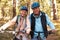 Senior couple on mountain bikes in a forest, portrait