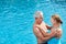 Senior couple in the outdoor pool looks in love