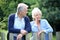 Senior couple outdoors standing by the fence