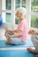 Senior couple performing yoga on exercise mat