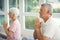 Senior couple performing yoga on exercise mat