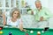 Senior couple playing billiard