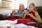 Senior Couple With Poor Diet Keeping Warm Under Blanket