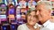 Senior couple posing on blurred casino background