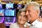 Senior couple posing on blurred casino background