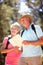 Senior couple reading map on country walk