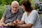 Senior couple reading text messages on mobile phone