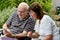 Senior couple reading text messages on mobile phone